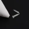glass-nose-stud-black-background Clear glass L-shaped nose stud on black fabric background