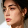 opal-nose-stud-worn-on-model Woman wearing a small opal stud in her left nostril